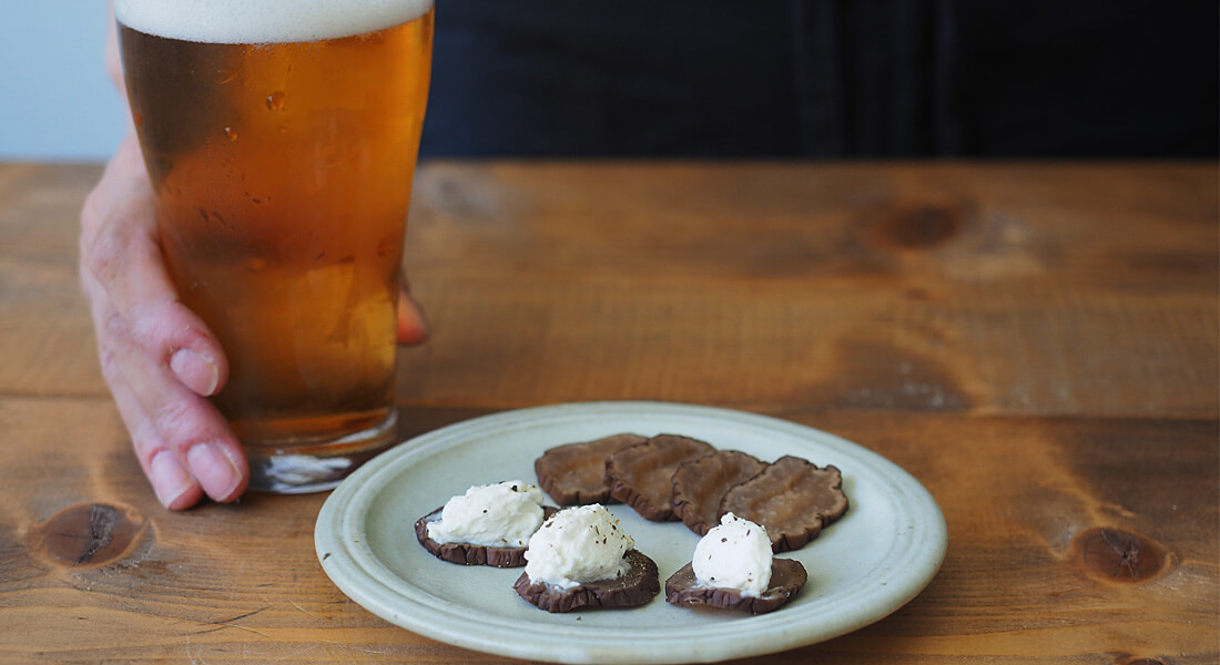 いぶりがっこクリームチーズとビールの写真