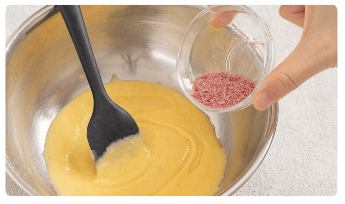 桜の花フレークを生地に加えている写真